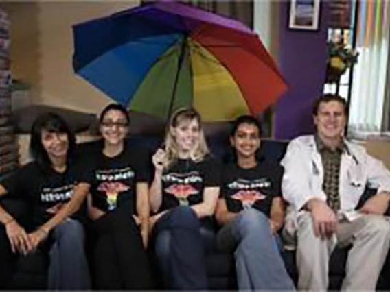 MedPride Students under a rainbow umbrella