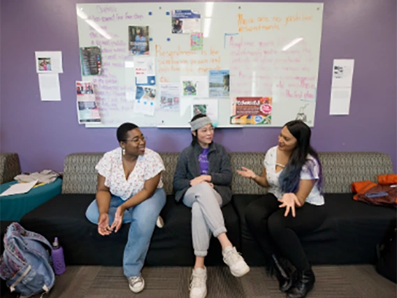 Members of LGBTQ sitting in common area talking