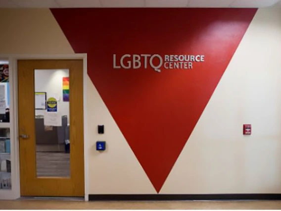 Hallway wall with "LGBTQ Resource Center" painted inside a red triangle