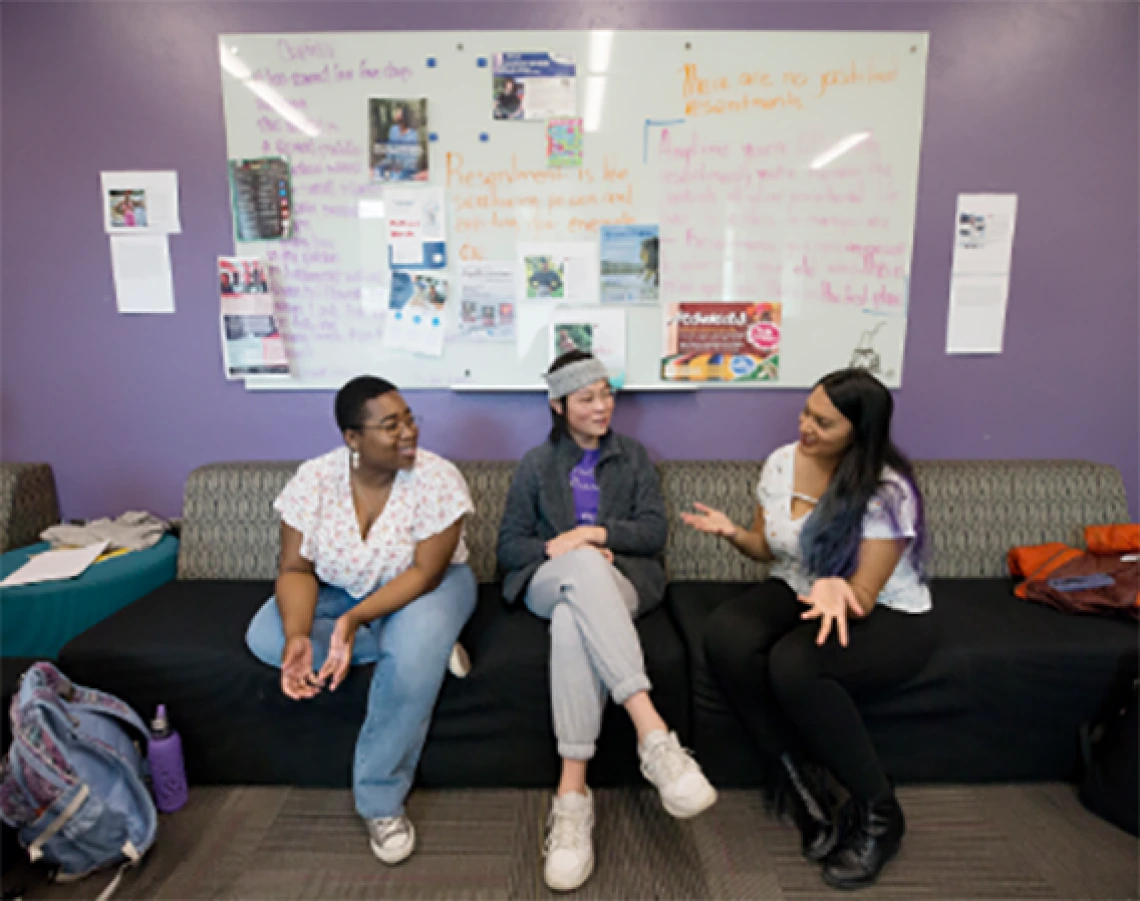 Members of LGBTQ sitting in common area talking